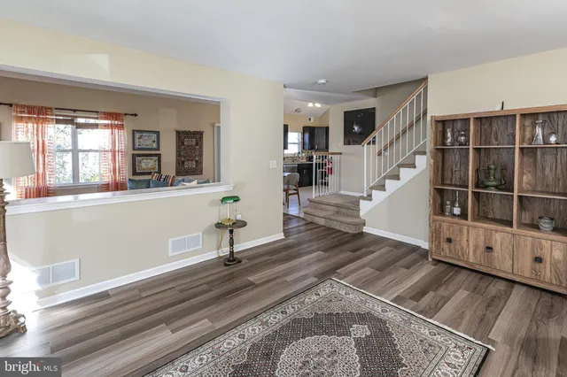 a view of a room with wooden floor and stairs