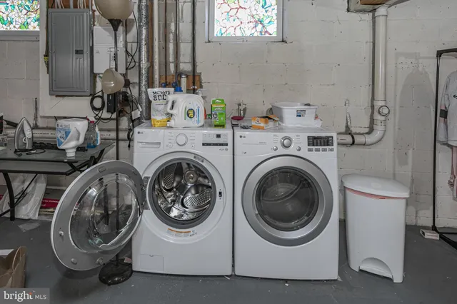 a utility room with sink dryer and washer