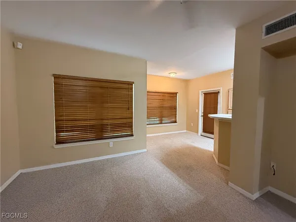 a spacious bathroom with a double vanity sink toilet and a mirror