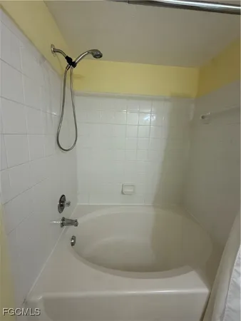 a bathroom with a shower and a bath tub