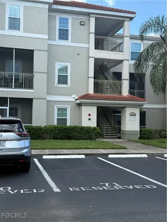 a front view of a residential apartment building with a yard