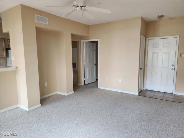 a kitchen with white cabinets and white appliances