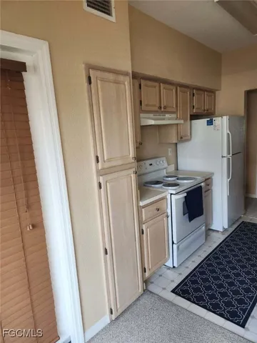 a kitchen with a sink stove and refrigerator