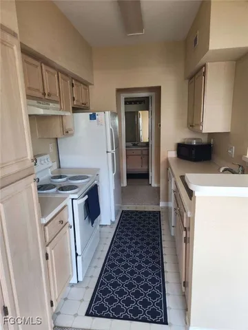 a kitchen with a refrigerator sink and stove