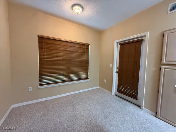 a view of empty room with fireplace and ceiling fan
