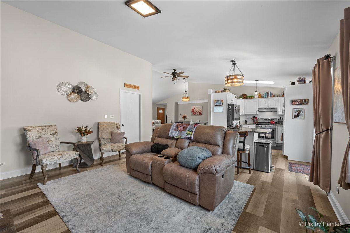 920 Mensching Road Roselle, IL 60172 - Photo 13 of 40 a living room with furniture a rug and kitchen view