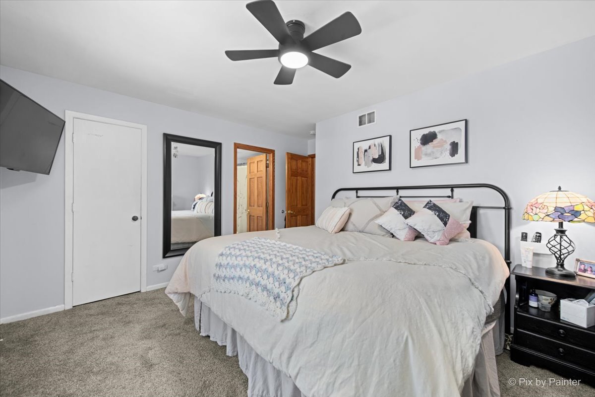 920 Mensching Road Roselle, IL 60172 - Photo 16 of 40 a bedroom with bed and a chandelier