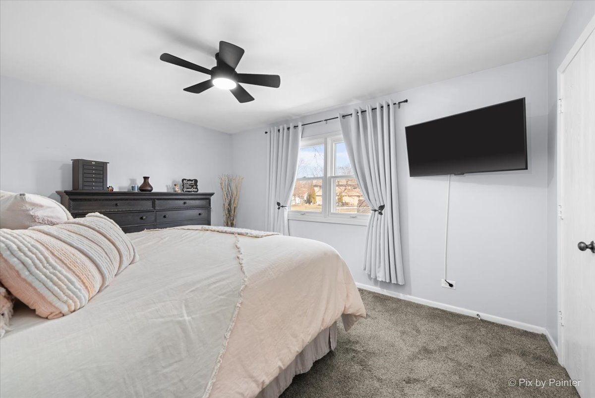 920 Mensching Road Roselle, IL 60172 - Photo 17 of 40 a bedroom with a bed and a flat screen tv