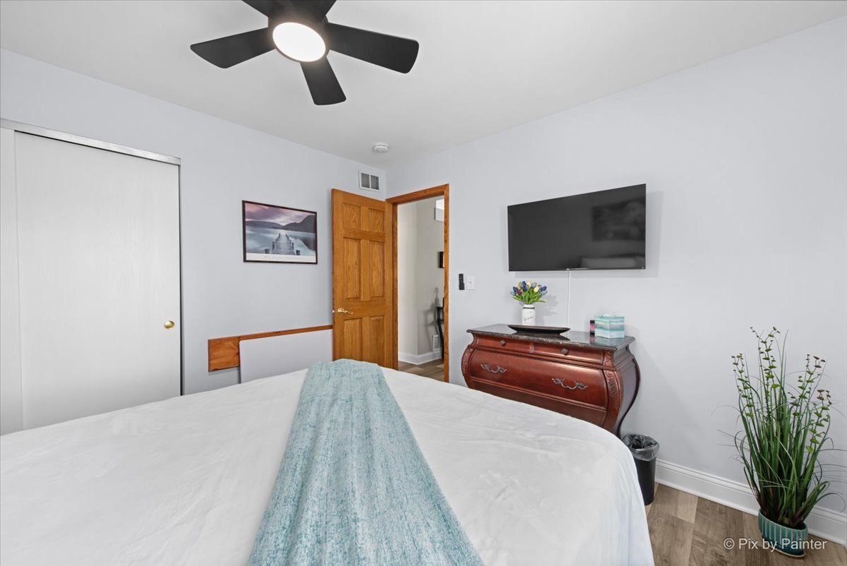 920 Mensching Road Roselle, IL 60172 - Photo 20 of 40 a bedroom with a bed and a flat screen tv