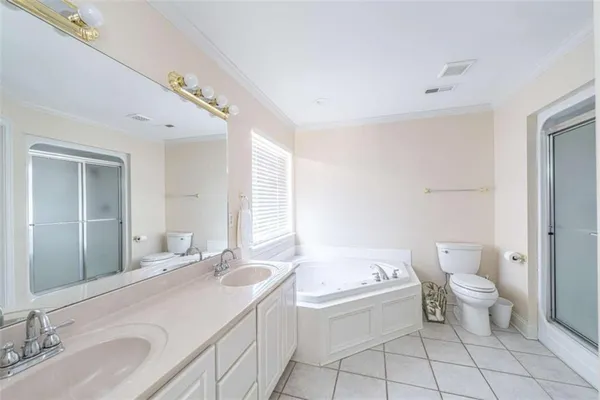 a bathroom with a granite countertop sink a toilet and bathtub