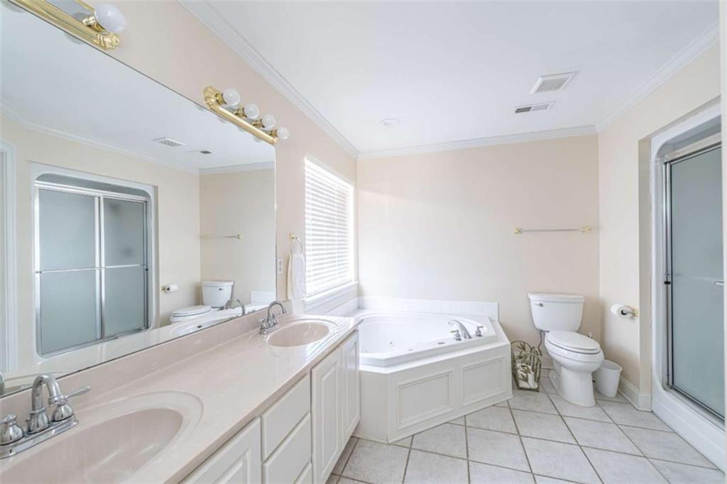 14 Limon Place Southwest Rome, GA 30165 - Photo 14 of 27 a bathroom with a granite countertop sink a toilet and bathtub
