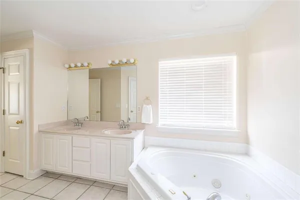 a bathroom with a tub sink and a window