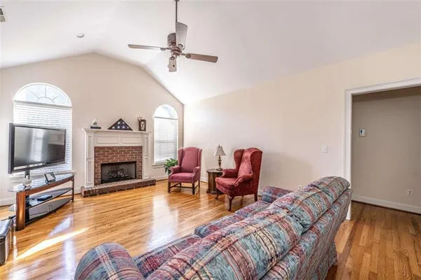 a living room with furniture fireplace and flat screen tv