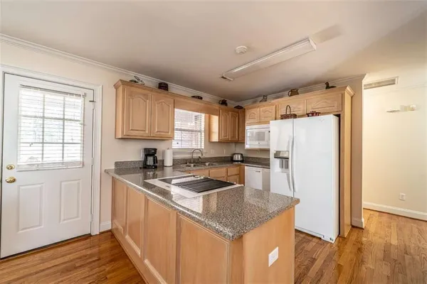 a kitchen with stainless steel appliances granite countertop a sink refrigerator and microwave