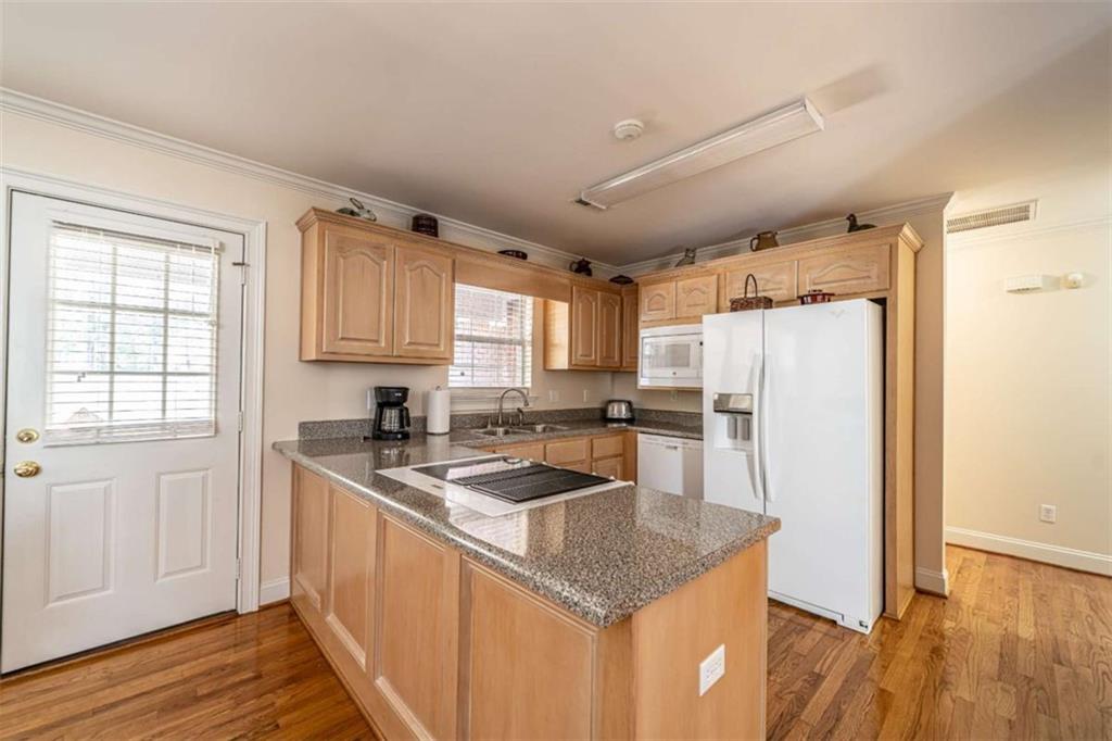 14 Limon Place Southwest Rome, GA 30165 - Photo 5 of 27 a kitchen with stainless steel appliances granite countertop a sink refrigerator and microwave