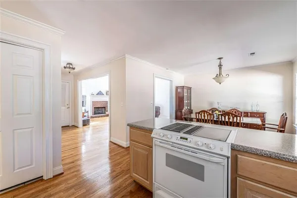 a kitchen that has a stove and a wooden floor