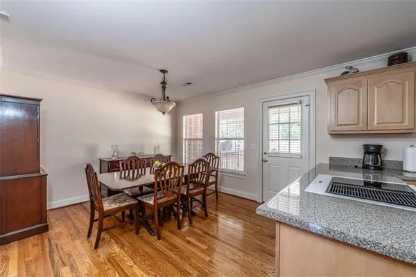 a view of a dining room with furniture and wooden floor
