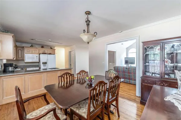 a view of a dining room with furniture large windows and wooden floor