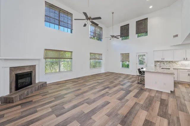 a living room with furniture kitchen view and a fireplace