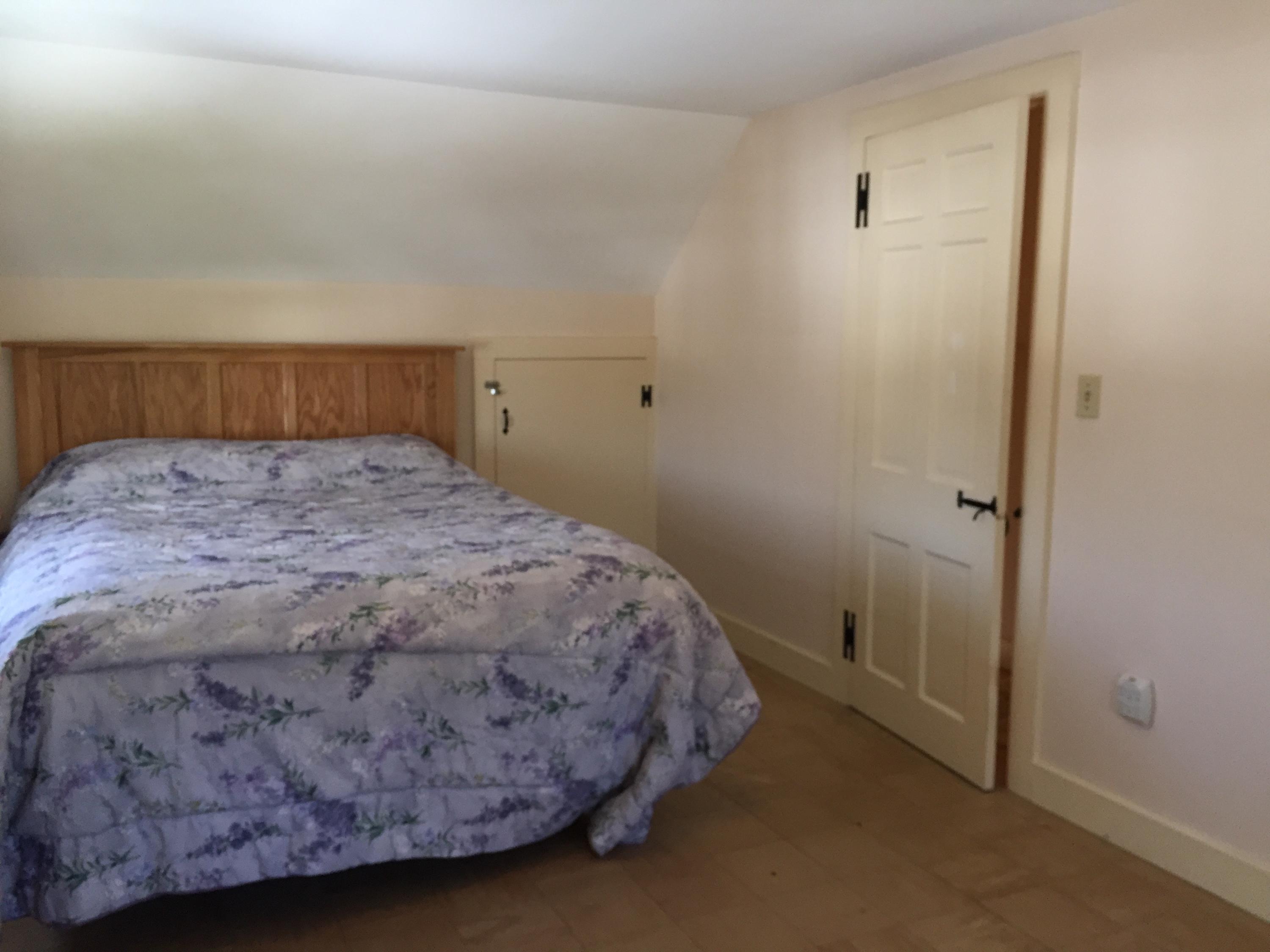 20 Depot Road Eastham, MA 02642 - Photo 8 of 13 a bedroom with a bed and wooden floor