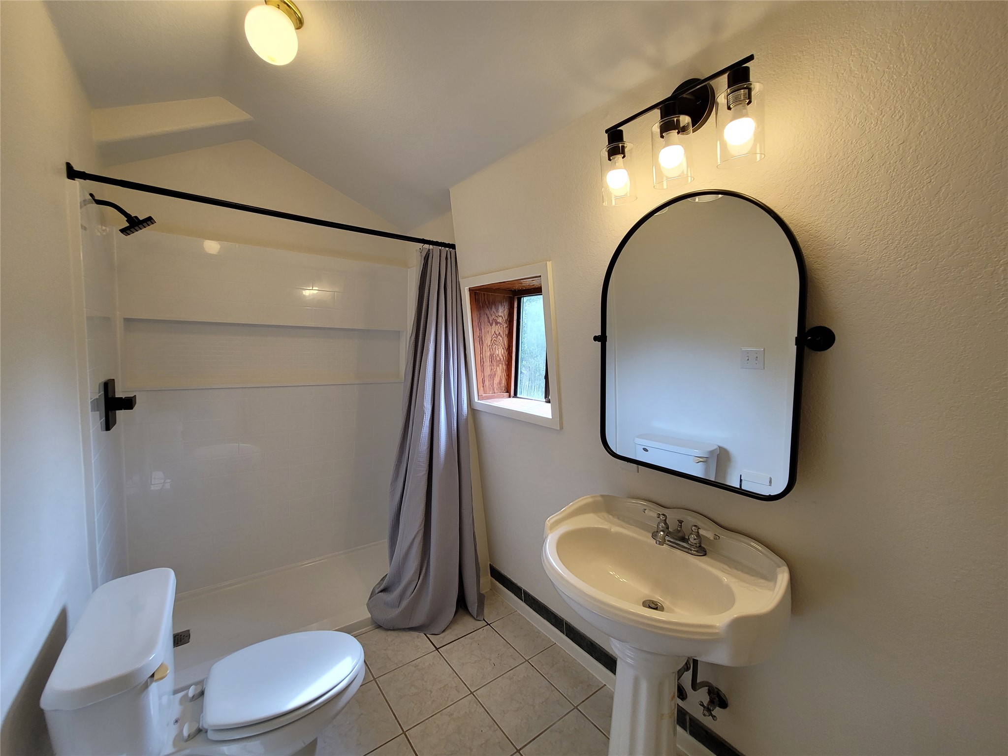 281 Earl Callahan Road, Unit A Cedar Creek, TX 78612 - Photo 29 of 39 a bathroom with a toilet a sink and mirror