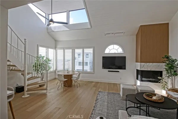 a living room with furniture a fireplace and a flat screen tv