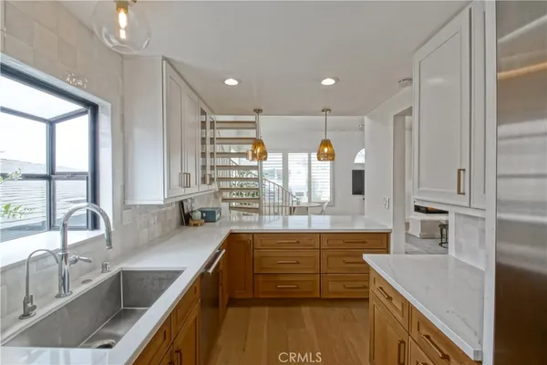 a kitchen with stainless steel appliances granite countertop a sink stove and cabinets