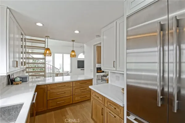 a kitchen with stainless steel appliances granite countertop sink stove and refrigerator