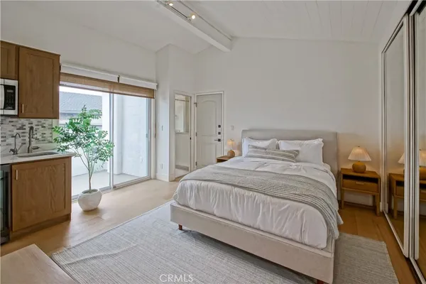 a bedroom with a large bed and a large window