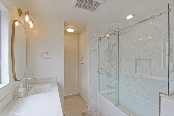 a bathroom with a sink a vanity and a mirror
