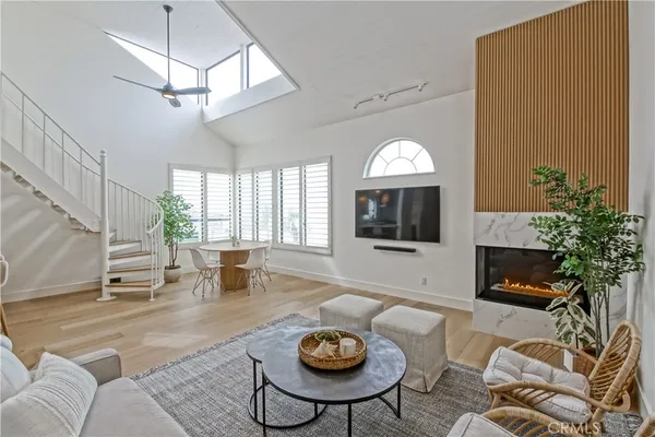 a living room with furniture a window and a flat screen tv