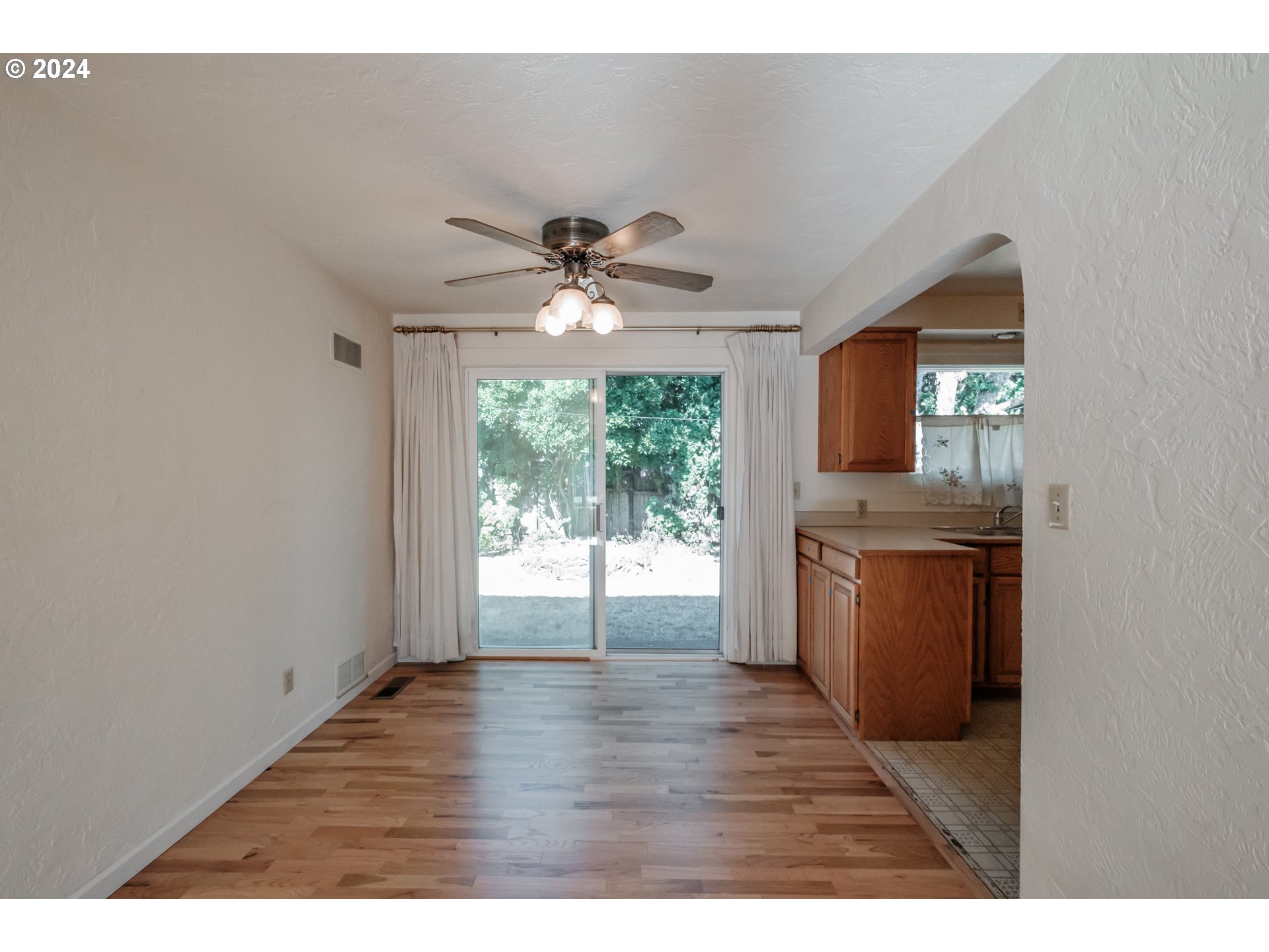 1620 Market Street Springfield, OR 97477 - Photo 11 of 31 a view of an empty room with a kitchen and wooden floor