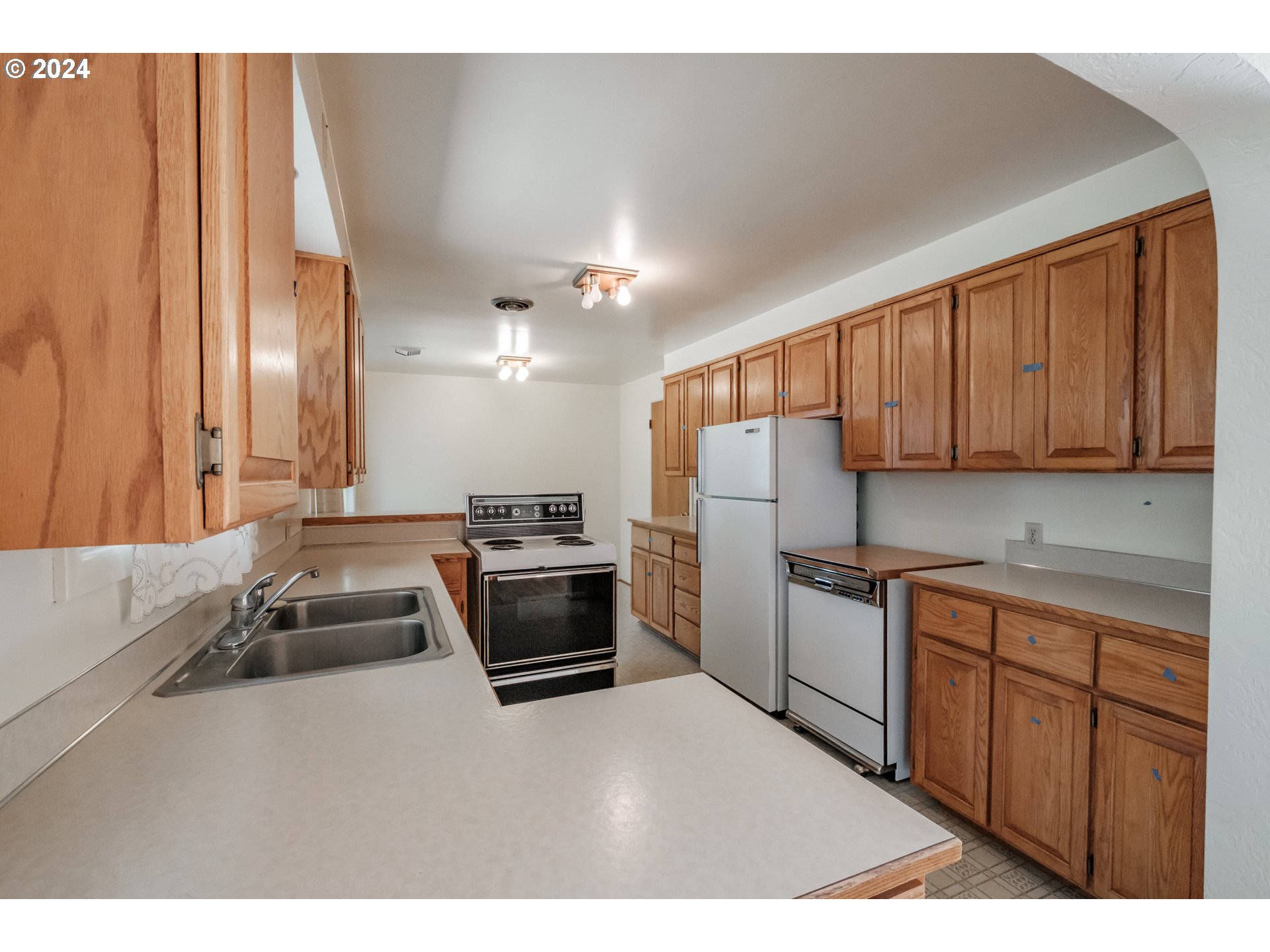 1620 Market Street Springfield, OR 97477 - Photo 13 of 31 a kitchen with stainless steel appliances a stove sink and cabinets