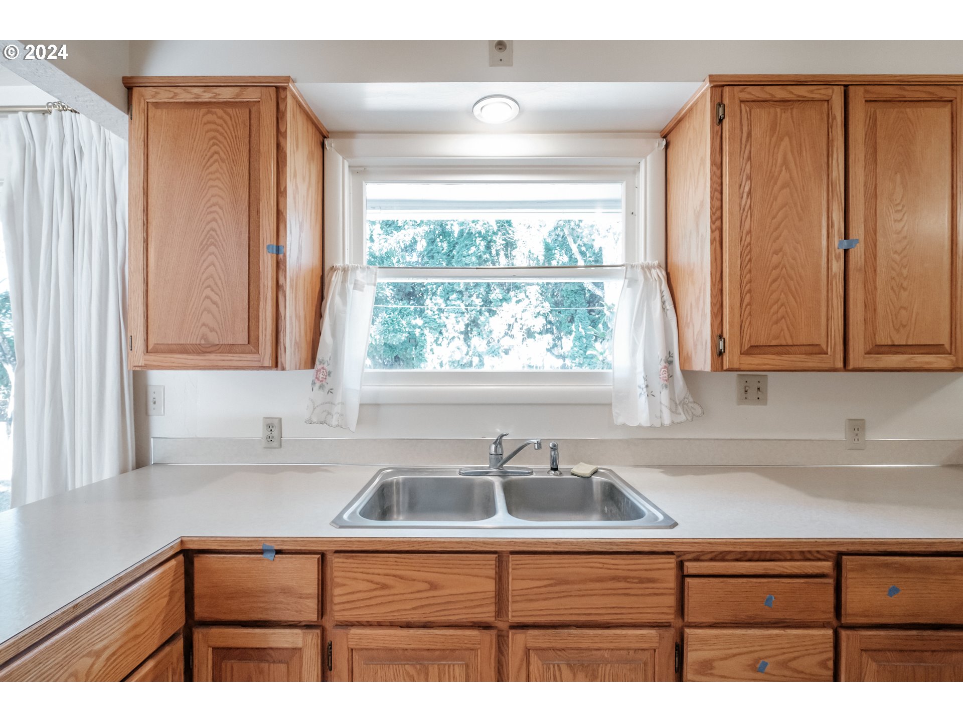 1620 Market Street Springfield, OR 97477 - Photo 16 of 31 a kitchen with stainless steel appliances a sink a window and cabinets