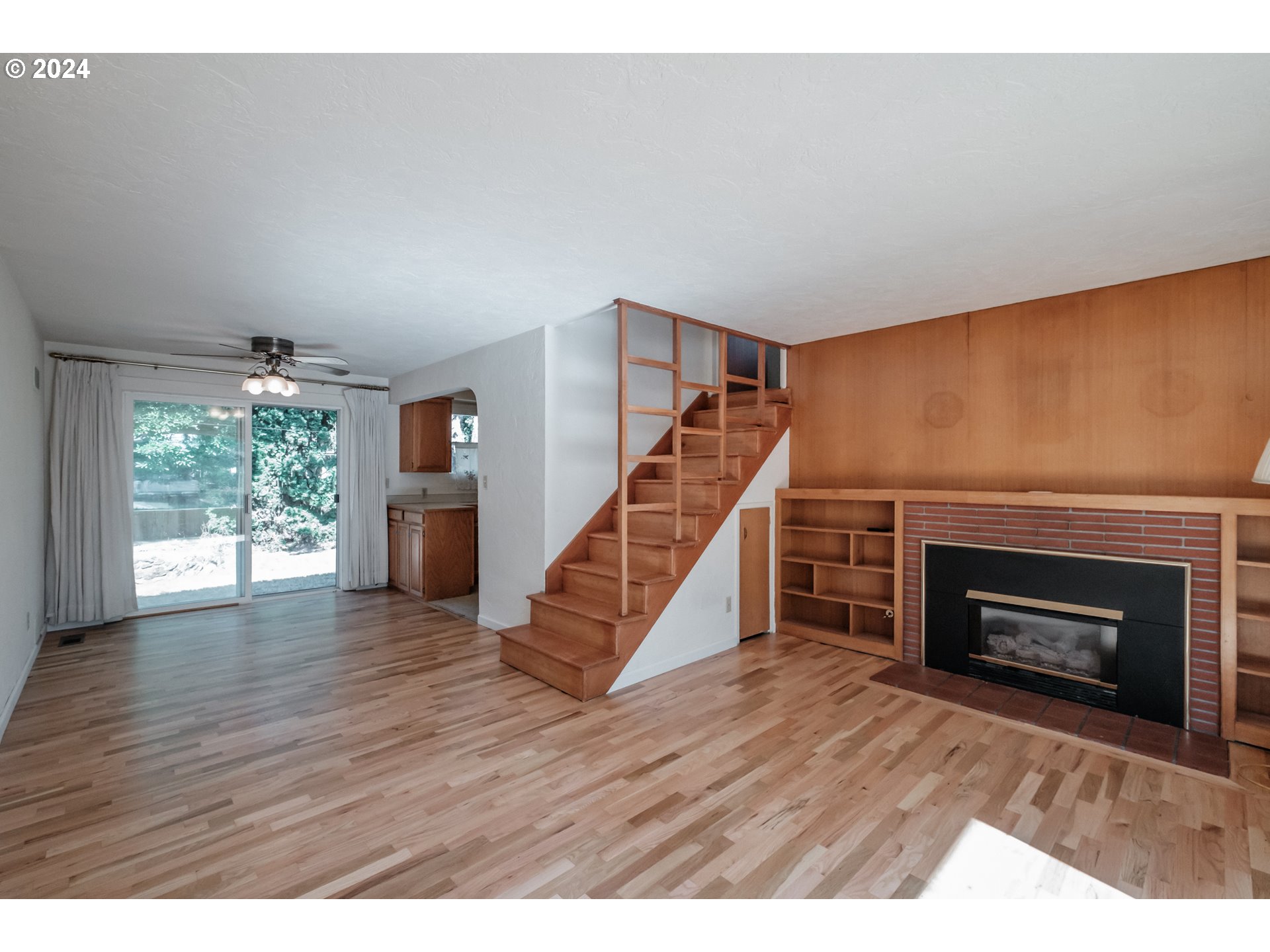 1620 Market Street Springfield, OR 97477 - Photo 5 of 31 a view of an empty room with wooden floor fireplace and a window
