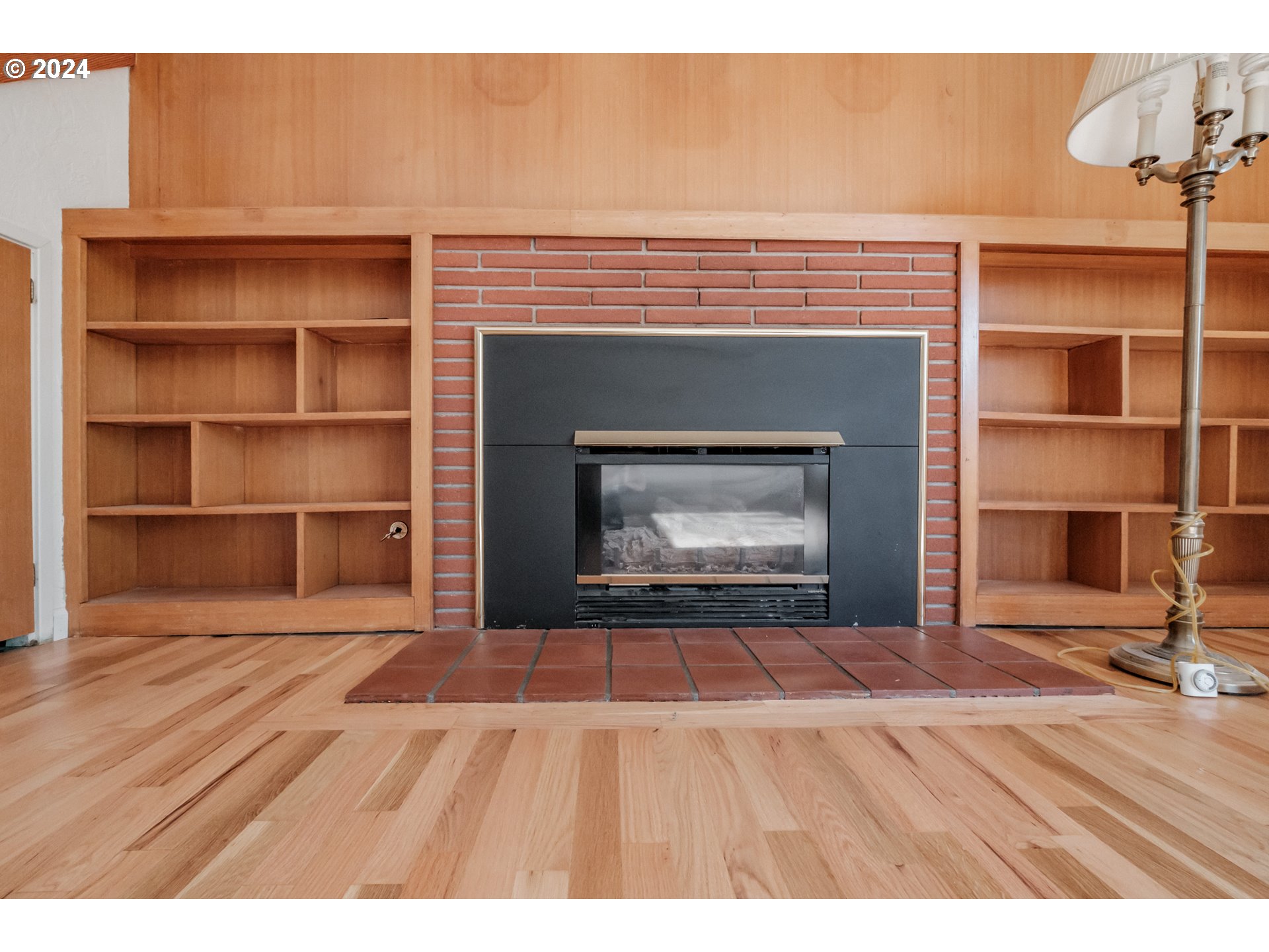 1620 Market Street Springfield, OR 97477 - Photo 7 of 31 a view of an empty room with a fireplace and a window