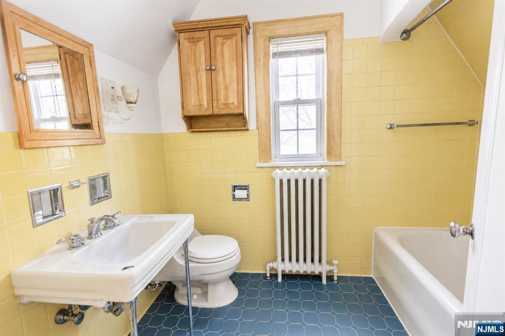298 Audubon Road Englewood, NJ 07631 - Photo 16 of 19 a bathroom with a sink a toilet and tub