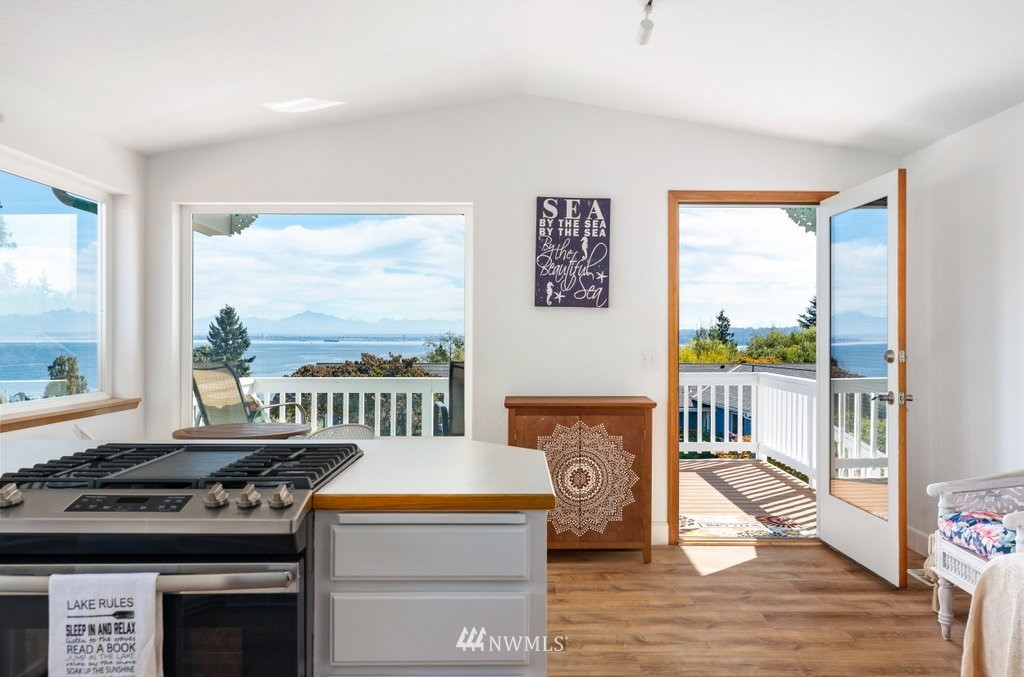 6623 Humphrey Road Clinton, WA 98236 - Photo 16 of 40 a view of a living room and a kitchen