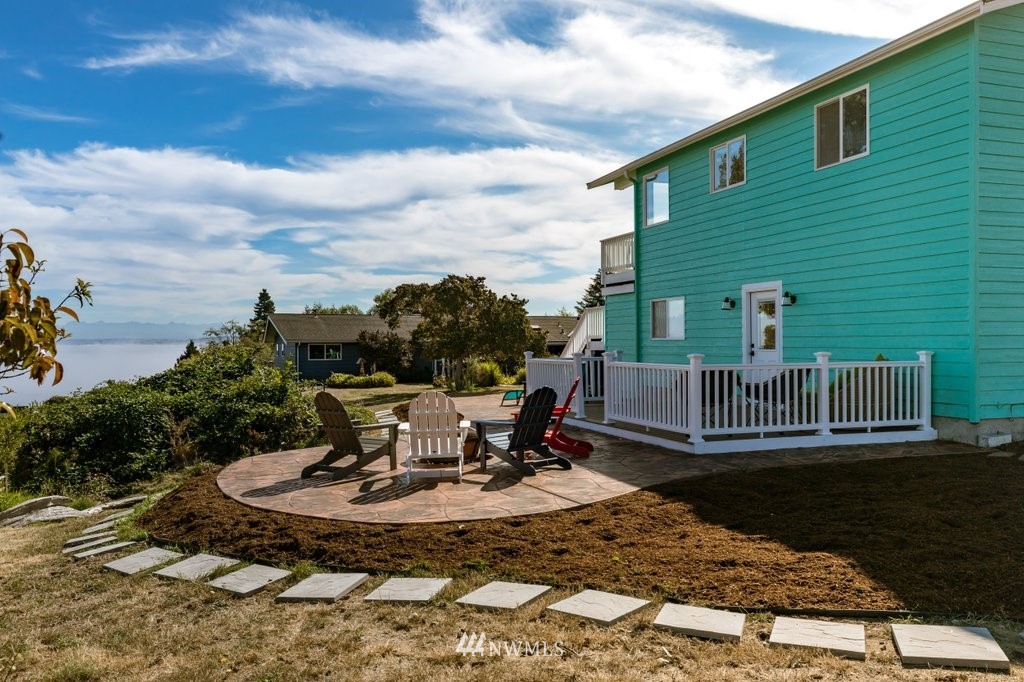 6623 Humphrey Road Clinton, WA 98236 - Photo 2 of 40 a view of a lake with a table and chairs