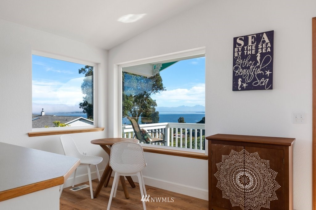 6623 Humphrey Road Clinton, WA 98236 - Photo 21 of 40 a view of a dining room with furniture window and wooden floor