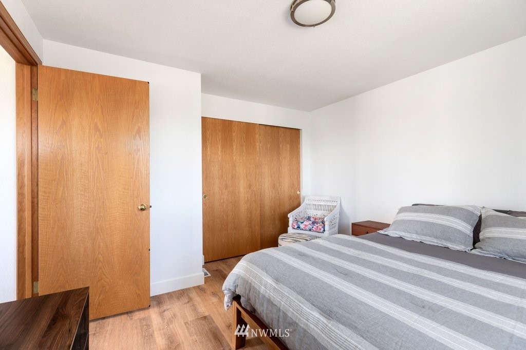 6623 Humphrey Road Clinton, WA 98236 - Photo 24 of 40 a bedroom with a bed and wooden floor