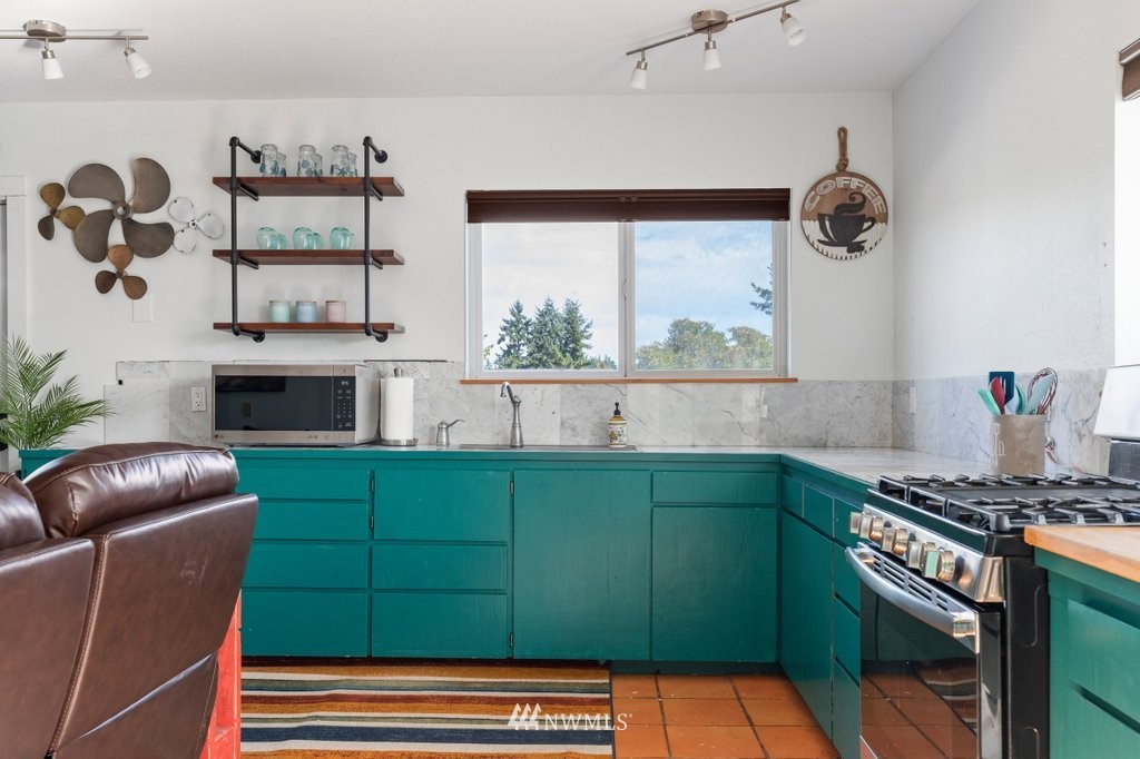 6623 Humphrey Road Clinton, WA 98236 - Photo 31 of 40 a kitchen with a cabinets and a stove
