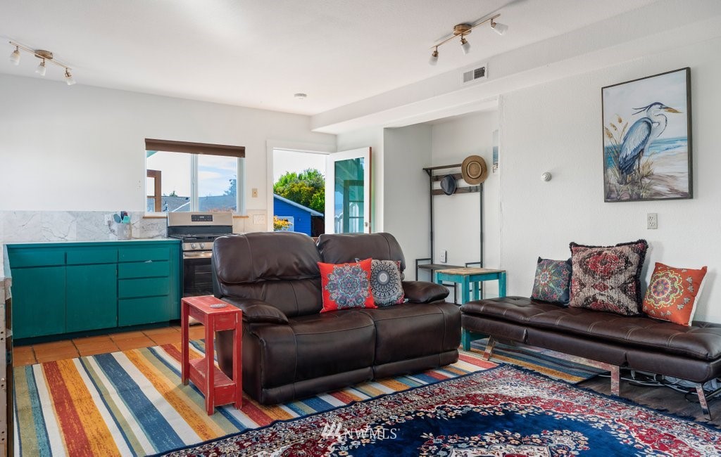 6623 Humphrey Road Clinton, WA 98236 - Photo 33 of 40 a living room with furniture and a wooden floor