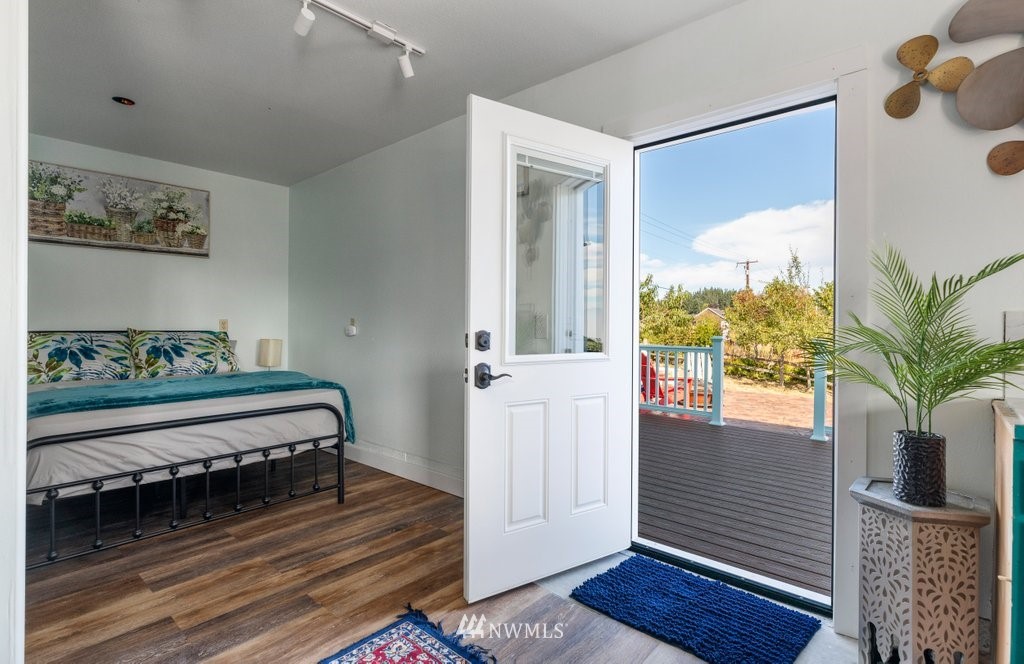 6623 Humphrey Road Clinton, WA 98236 - Photo 37 of 40 a view of bedroom with furniture and wooden floor