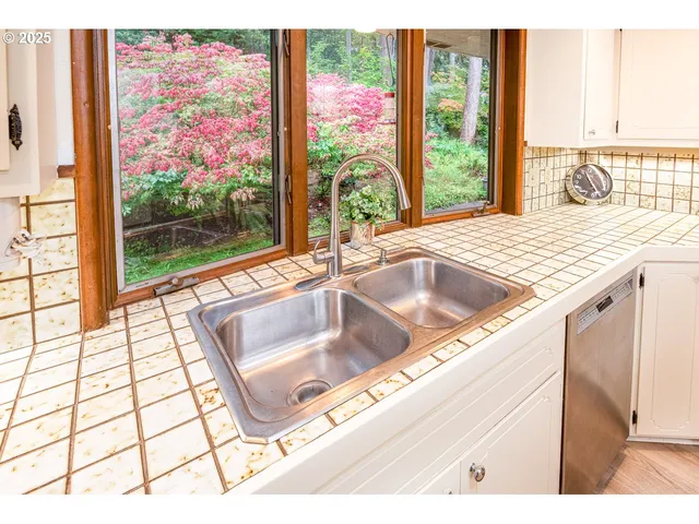 a kitchen with stainless steel appliances a refrigerator sink and cabinets