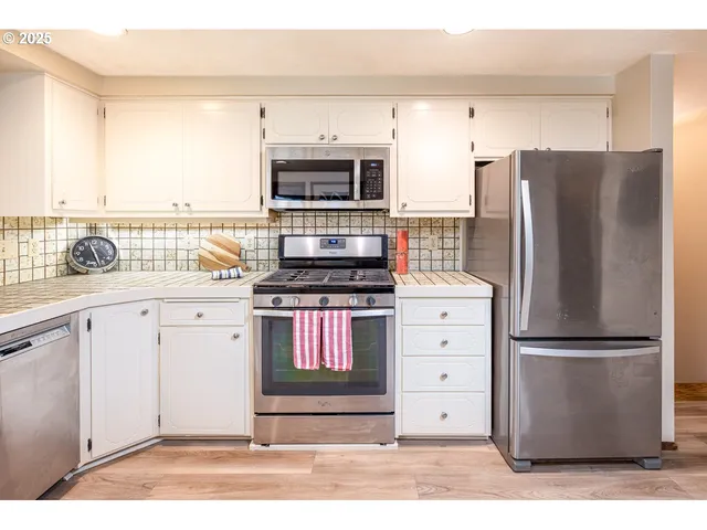 a bedroom with a bed and a painting on the wall