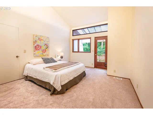 a bedroom with a bed and a large window