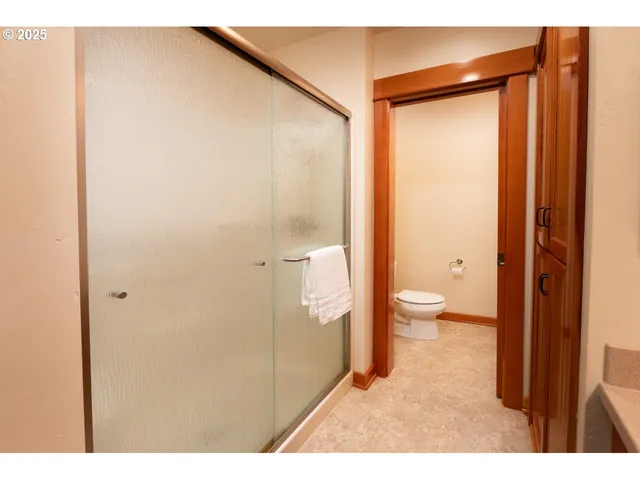 a view of a house with potted plants and a table and chairs