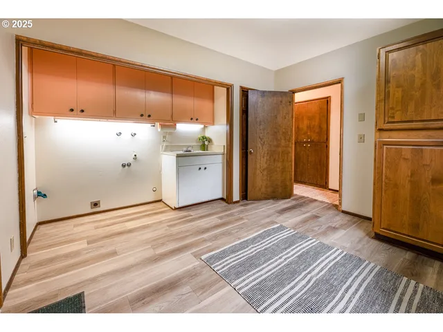 a view of a room with wooden floor and cabinet