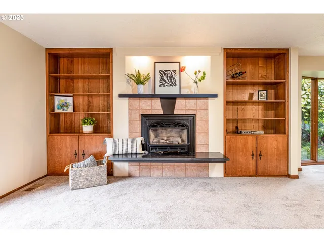 a living room with furniture a fireplace and a book shelf